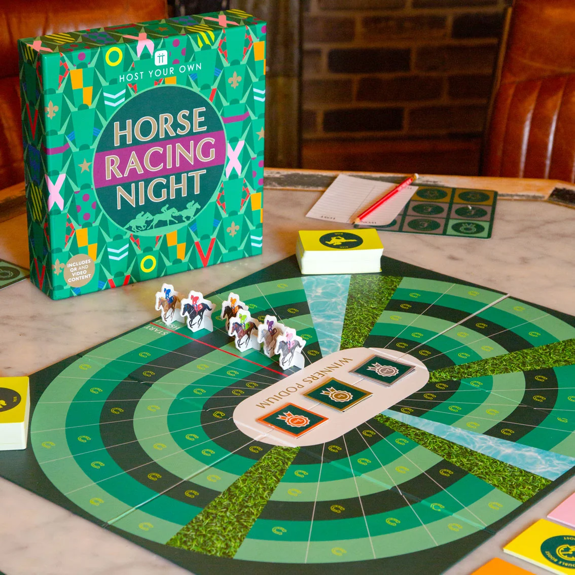 Horse Racing Night board game by Talking Tables with racecourse gameboard laid out on a table