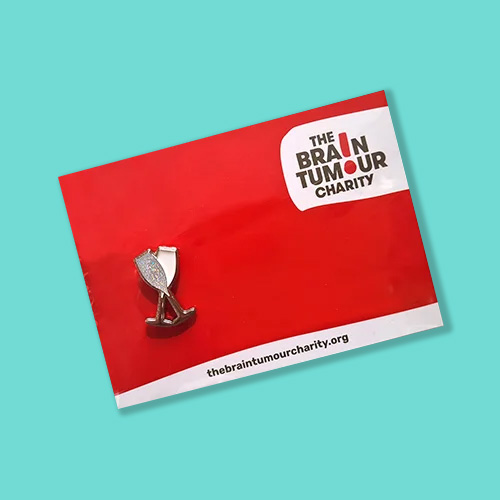 Celebration pin badge featuring two champagne glasses